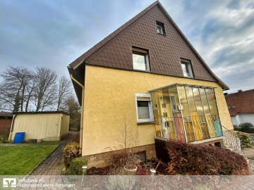 Seitliche Ansicht mit Hauseingang - Völksen: Platz für Ihre Ideen – Zwei Wohnungen, zwei Garagen, großes Grundstück…